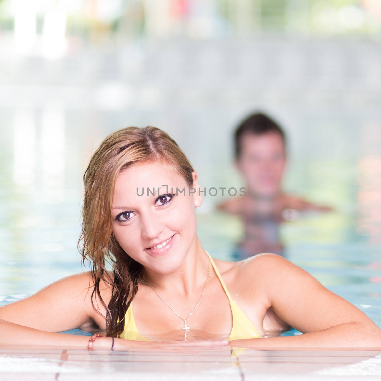 Young woman in the swimming pool. by kasto