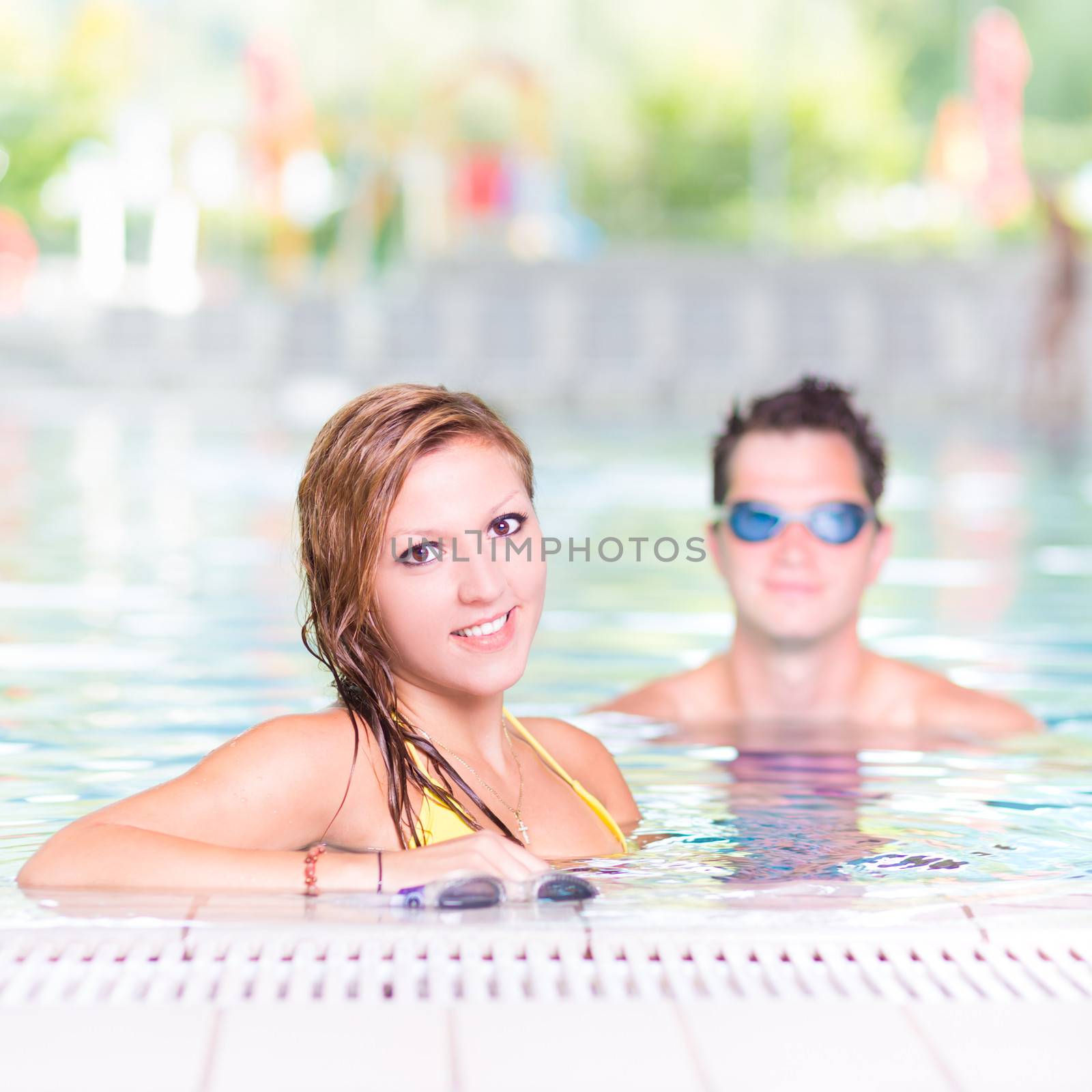 Young couple in the swimming pool. by kasto