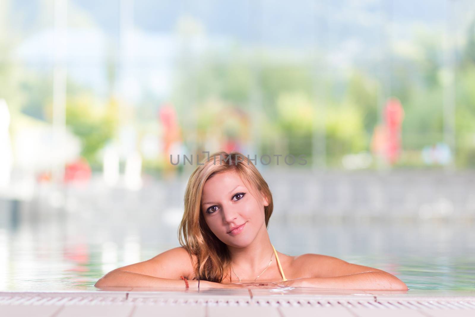 Young woman in the swimming pool. by kasto