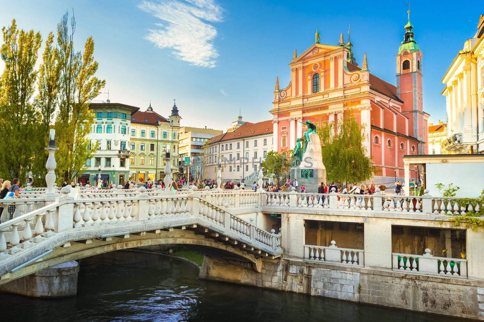 Romantic Ljubljana's city center:  river Ljubljanica, Triple Bridge (Tromostovje), Preseren square and Franciscan Church of the Annunciation; Ljubljana, Slovenia, Europe.