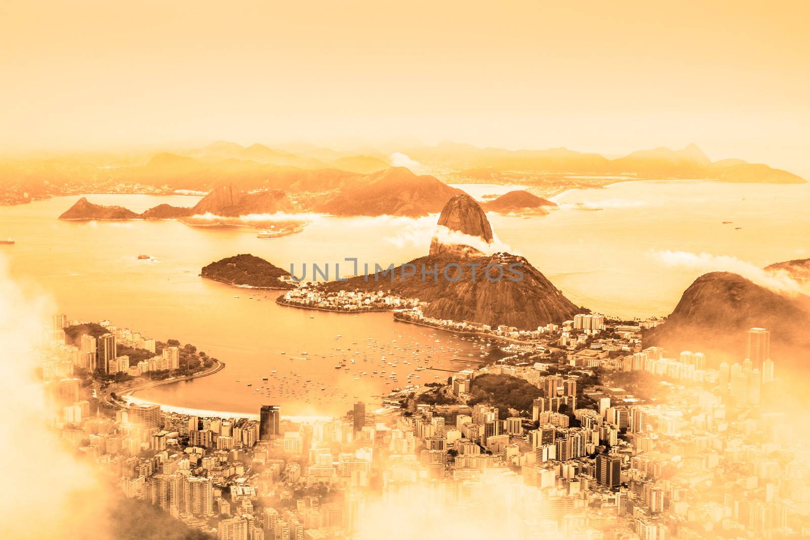 Rio de Janeiro, Brazil. Suggar Loaf and  Botafogo beach viewed from Corcovado at sunrise.