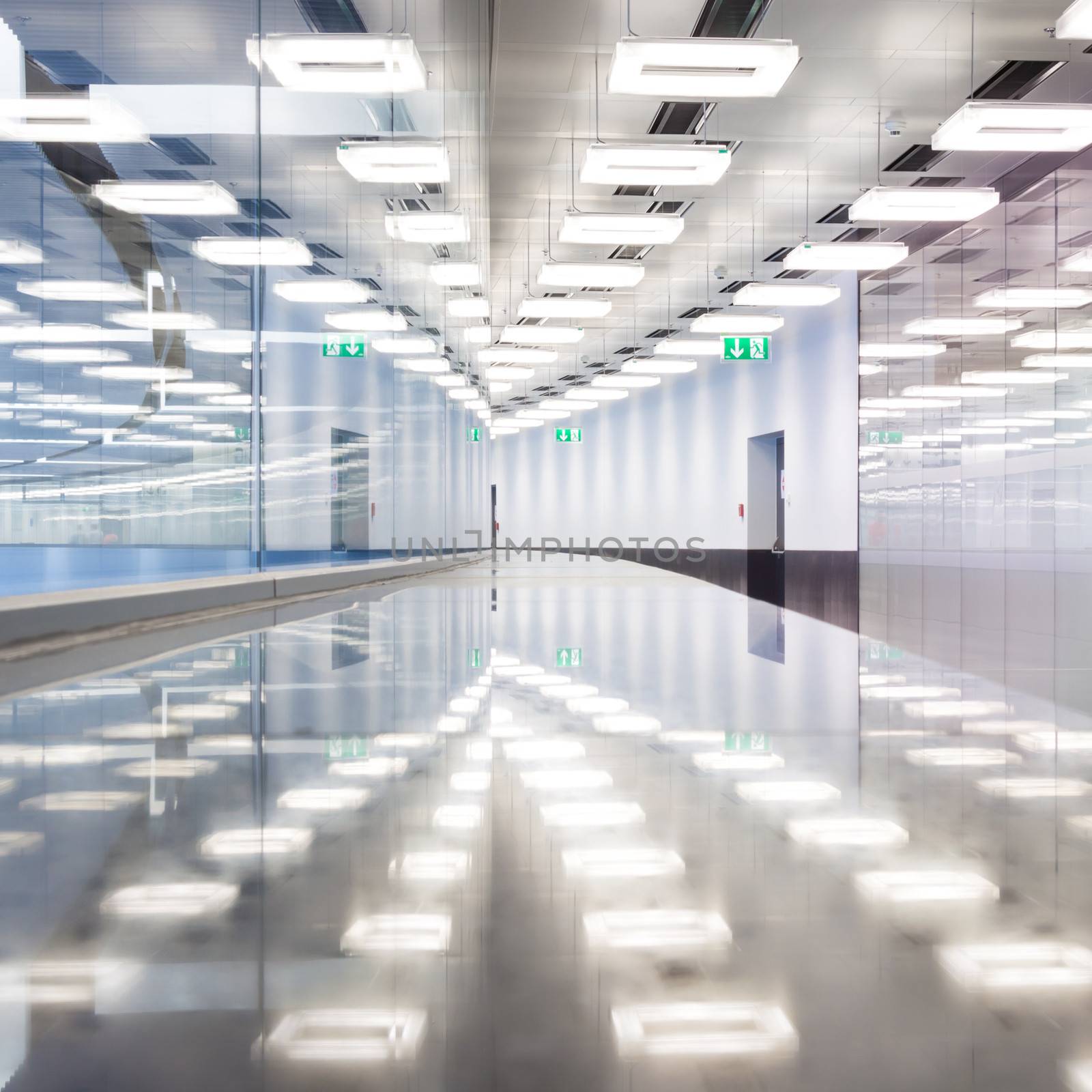 Contemporary illuminated airport terminal hall.