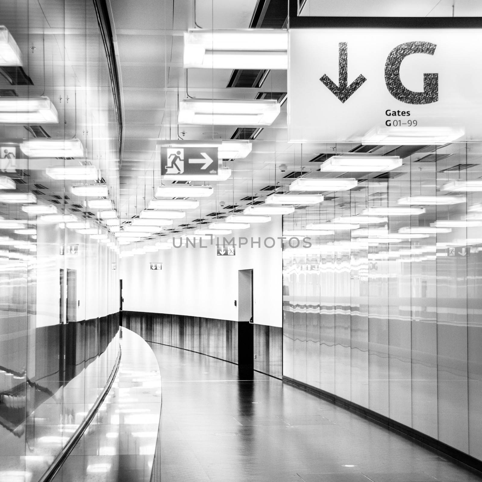 Contemporary illuminated airport terminal hall.