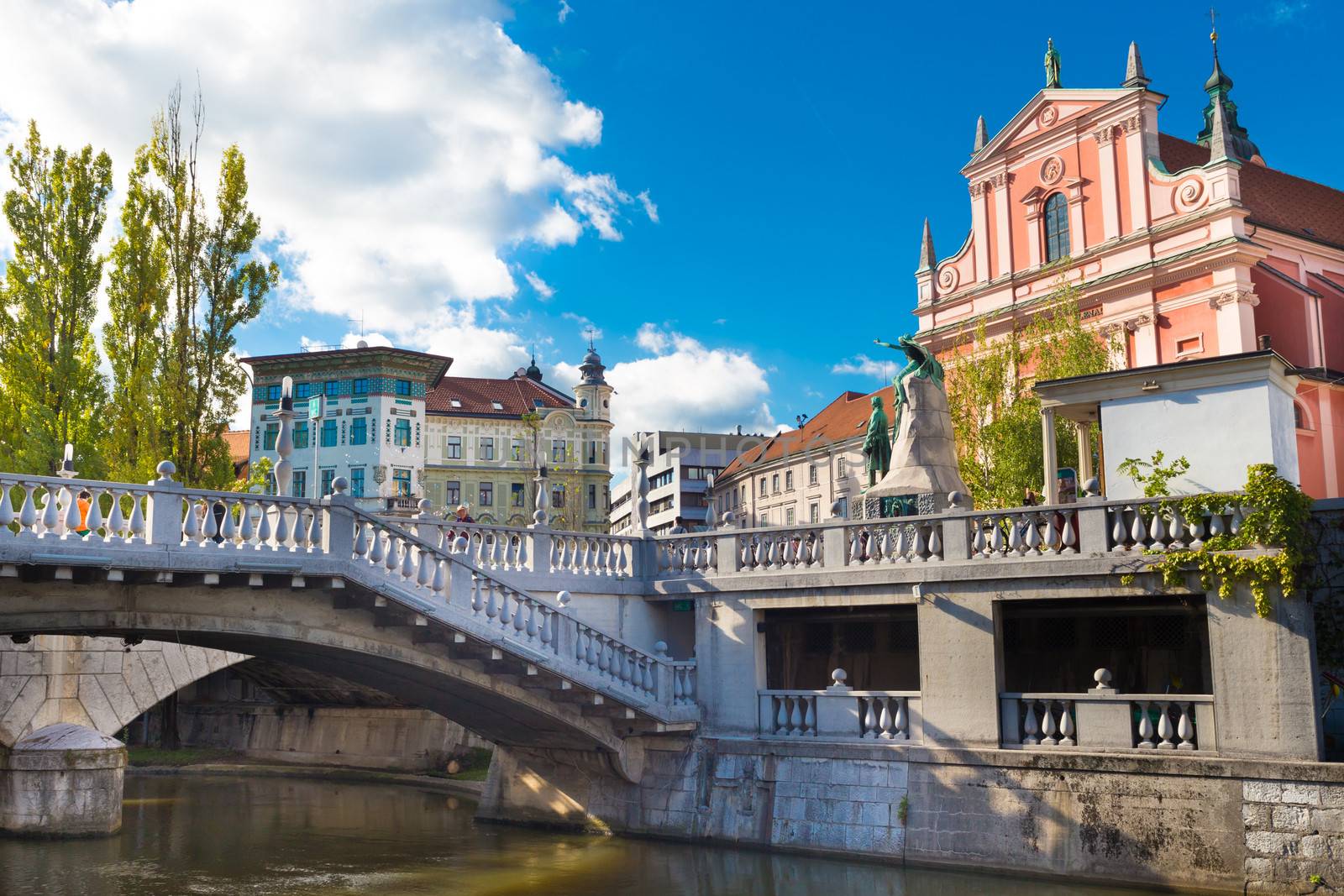 Romantic Ljubljana's city center:  river Ljubljanica, Triple Bridge (Tromostovje), Preseren square and Franciscan Church of the Annunciation; Ljubljana, Slovenia, Europe.