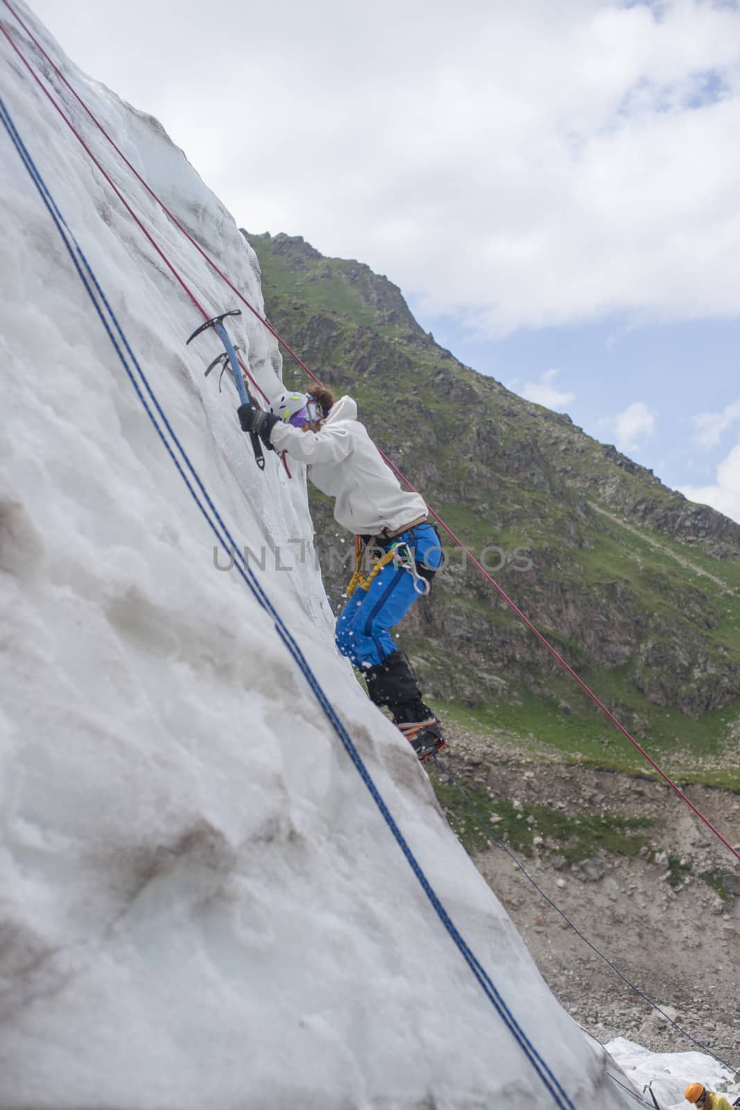 Girl climb up on the ice at glacier