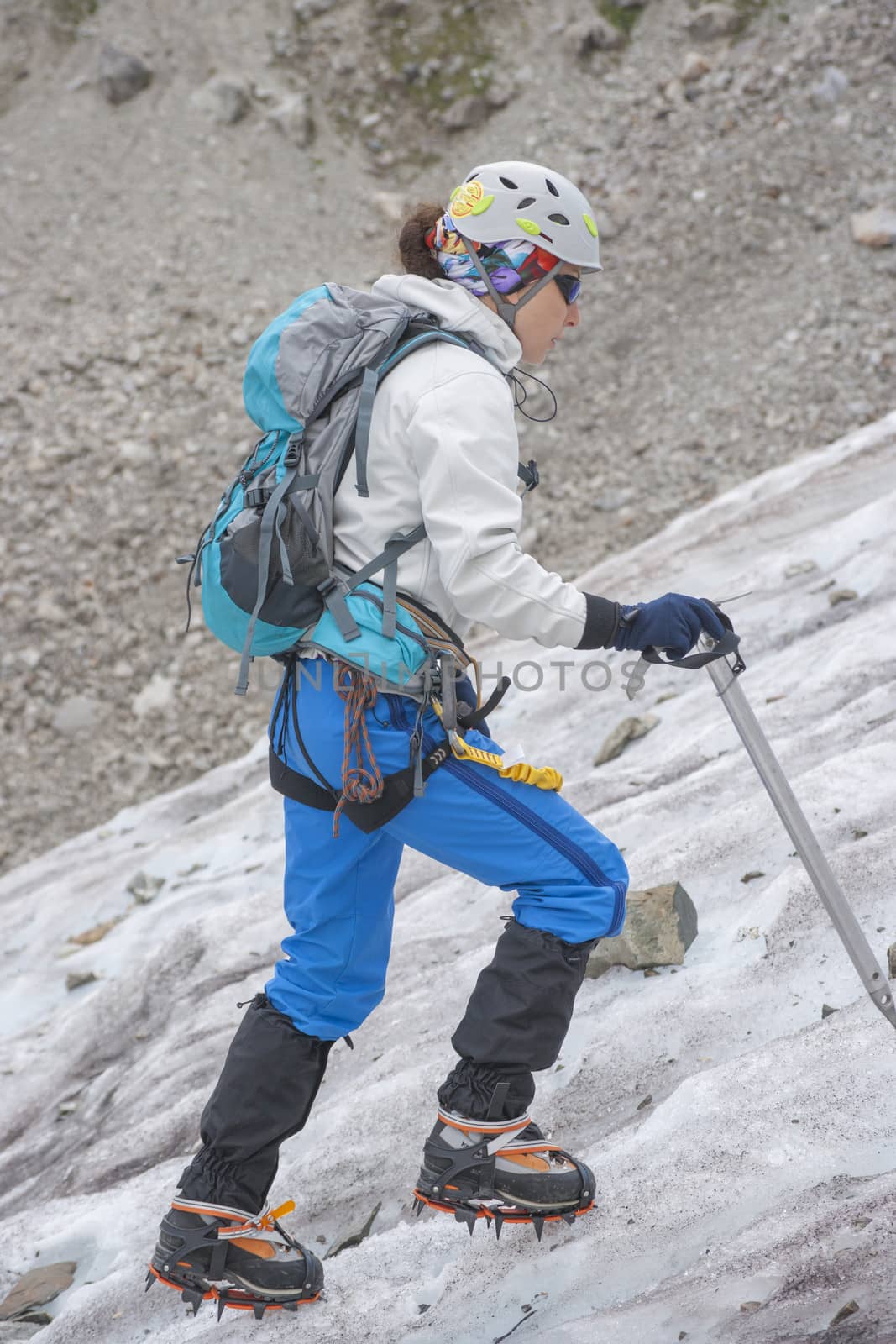 Girl climb up on the ice at glacier