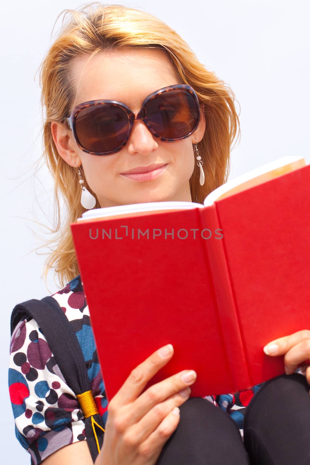 Attractive young lady reading a book. by kasto