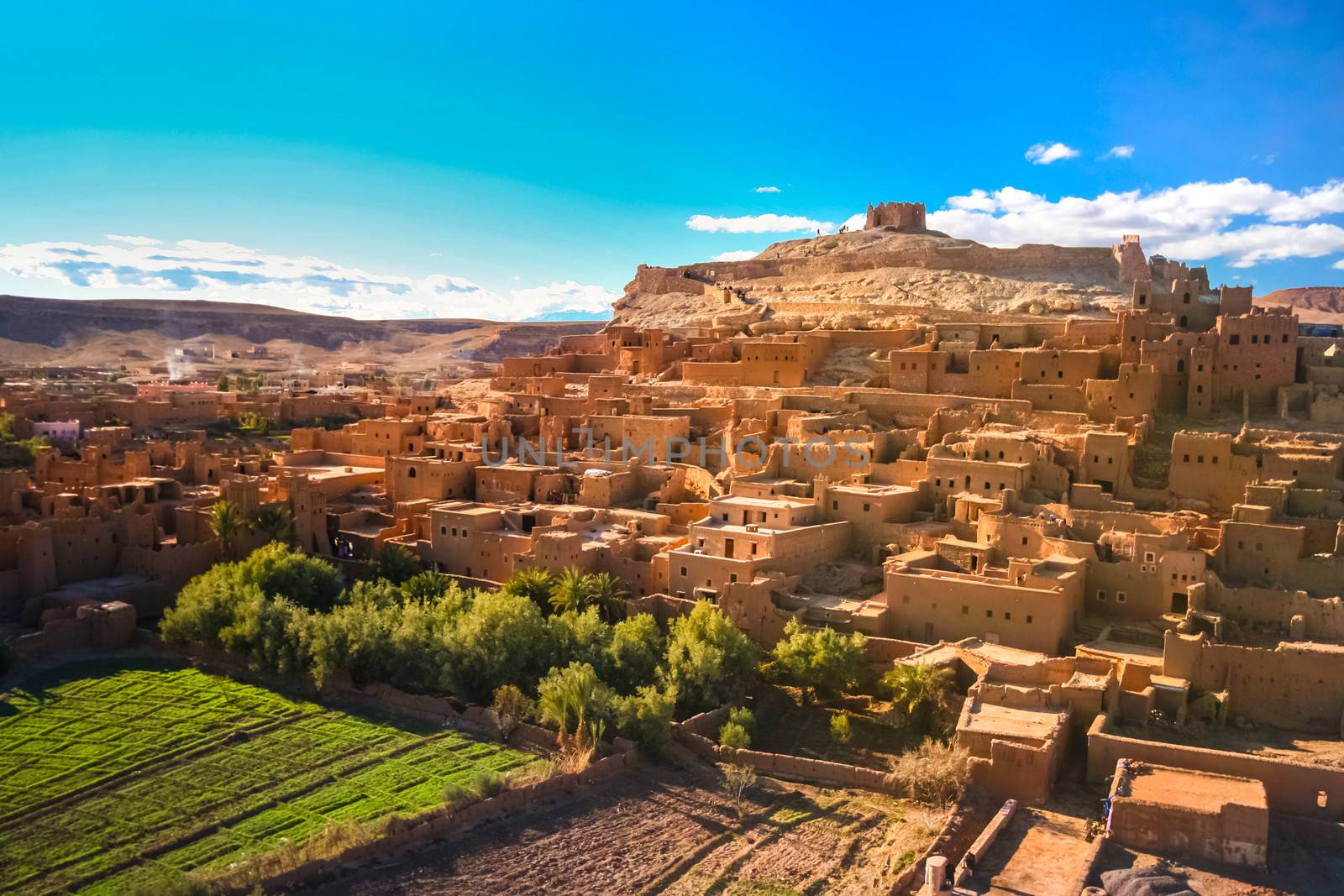 Ait Benhaddou is a fortified city, or ksar, along the former caravan route between the Sahara and Marrakech in present day Morocco. It is situated in Souss Massa Draa on a hill along the Ounila River and is known for its kasbah.