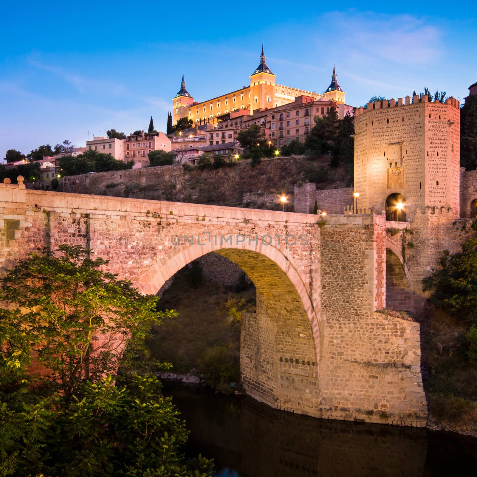 Panorama of the alcazar above the medieval San Martin bridge - Toledo, Spain