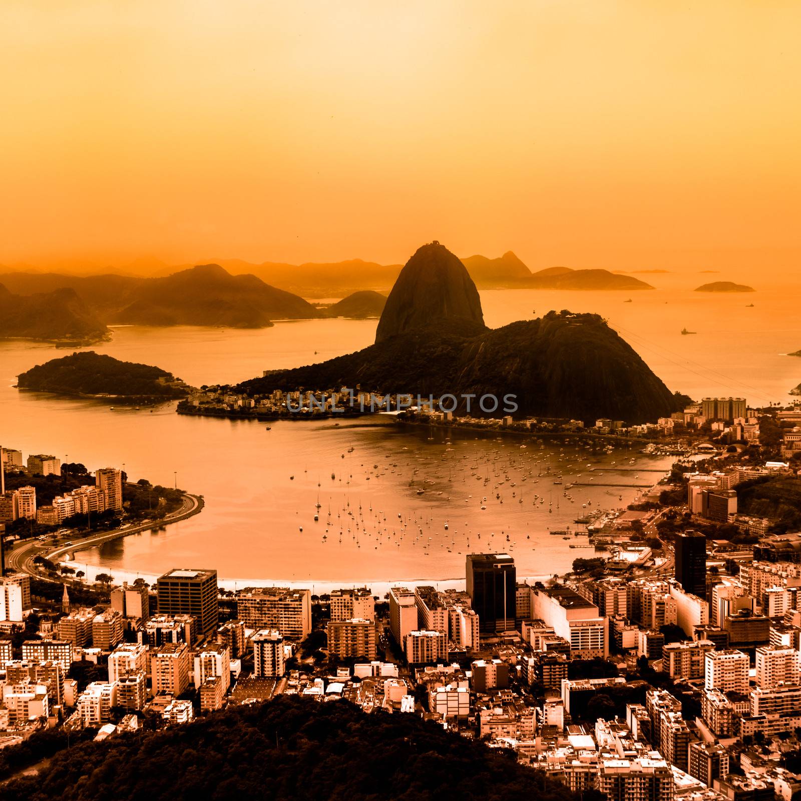Rio de Janeiro, Brazil. Suggar Loaf and  Botafogo beach viewed from Corcovado at sunset. Rio de Janeiro is the 2016 summer olympic games hosting city.