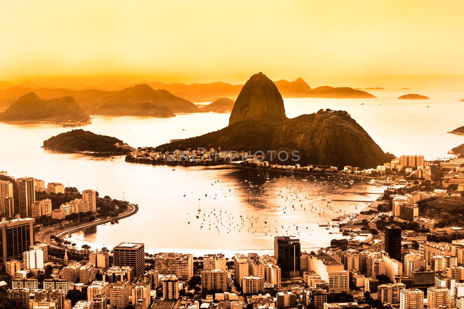 Rio de Janeiro, Brazil. Suggar Loaf and  Botafogo beach viewed from Corcovado at sunset.