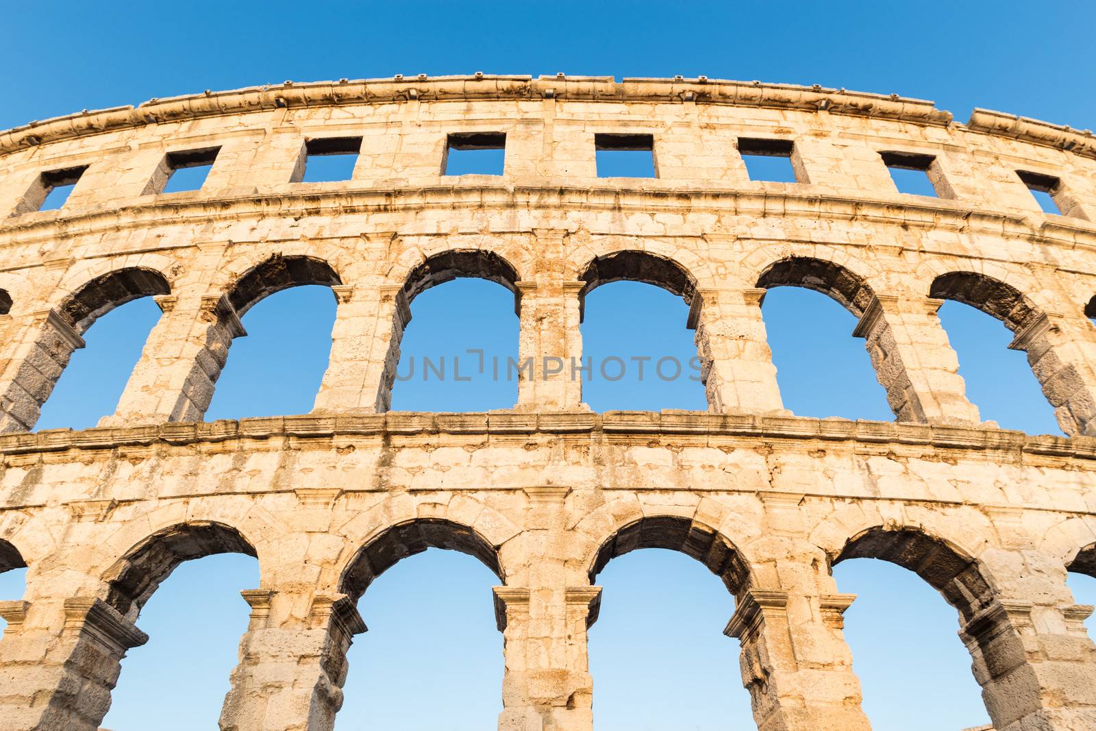 The Roman Amphitheater of Pula, Croatia shot at dusk. It was constructed in 27 - 68 AD and is among the six largest surviving Roman arenas in the World and best preserved ancient monument in Croatia.