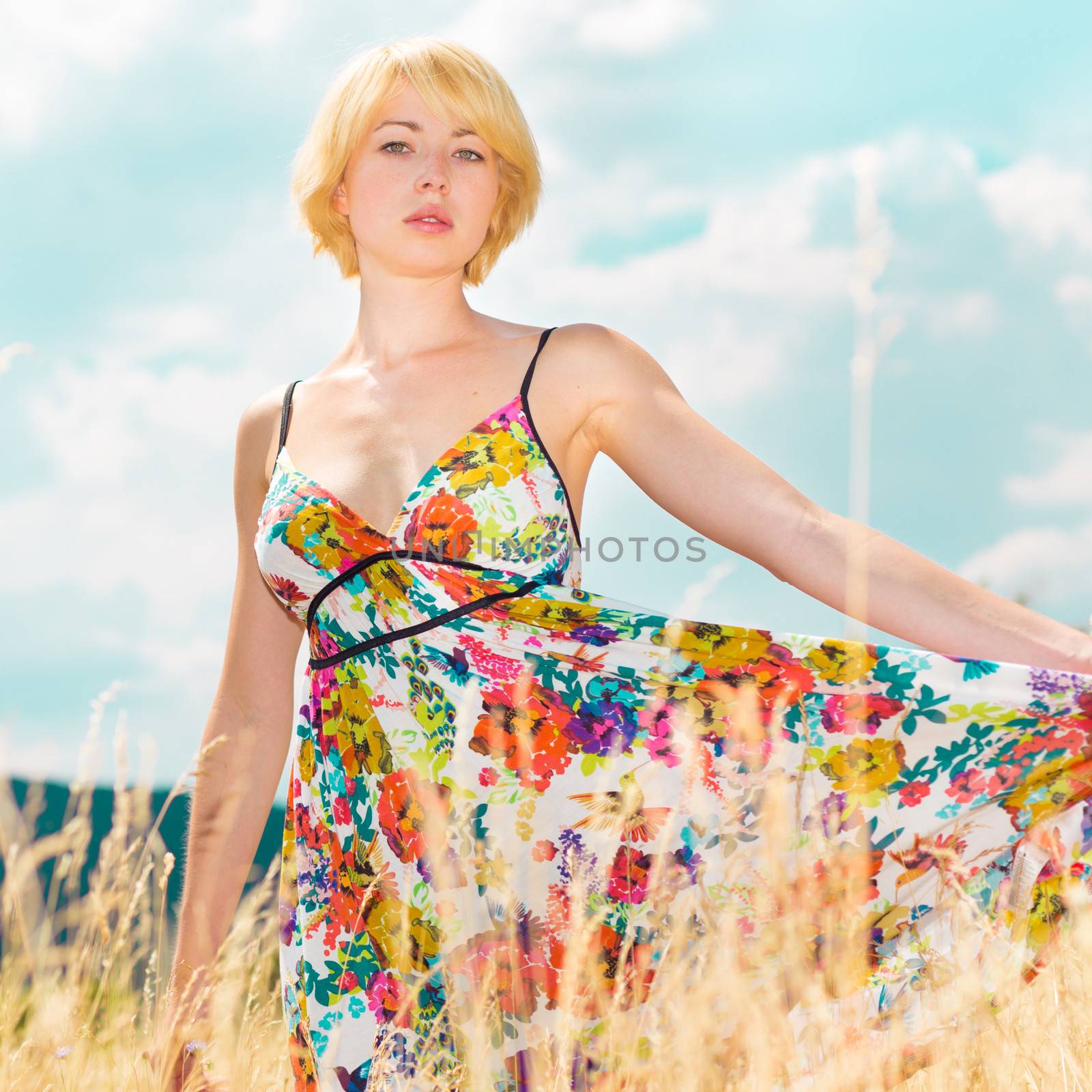 Lady enjoying the nature. Young woman enjoying the fresh air in summer meadow.