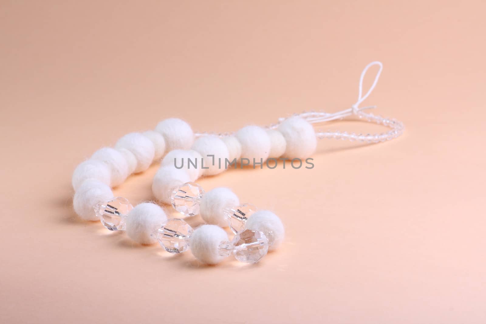 White beads at pink background by dedmorozz