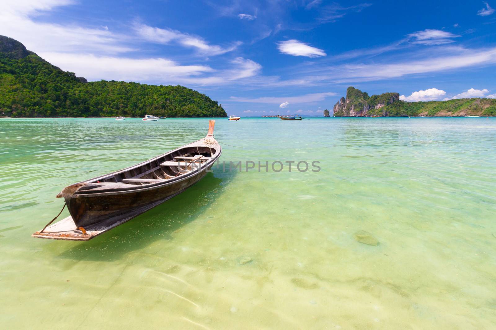 Wooden boat on a tropical beach. by kasto