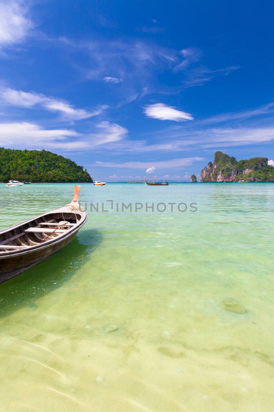 Traditional wooden  boats on a picture perfect tropical beach on Koh Phi Phi Island, Thailand, Asia.