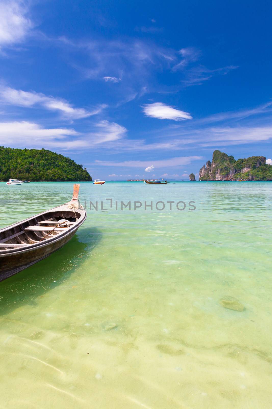 Wooden boat on a tropical beach. by kasto