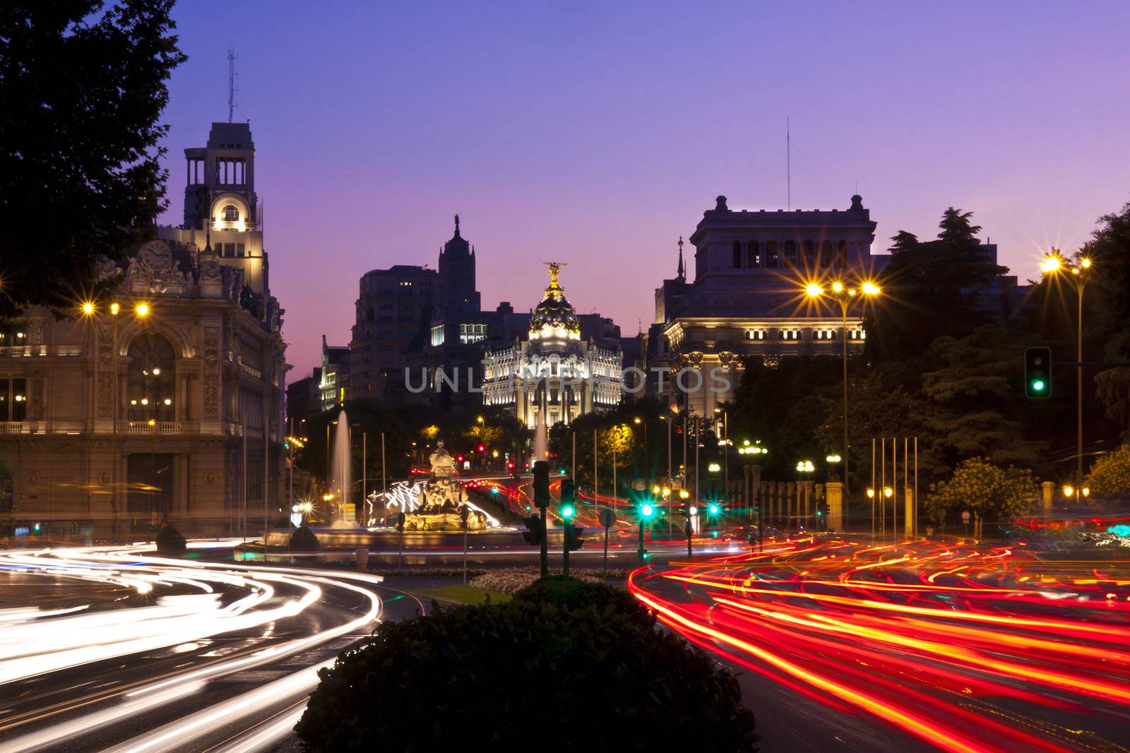 Rays of traffic lights on Calle de Alcala street and Cibeles square in Madrid at night. Spain.