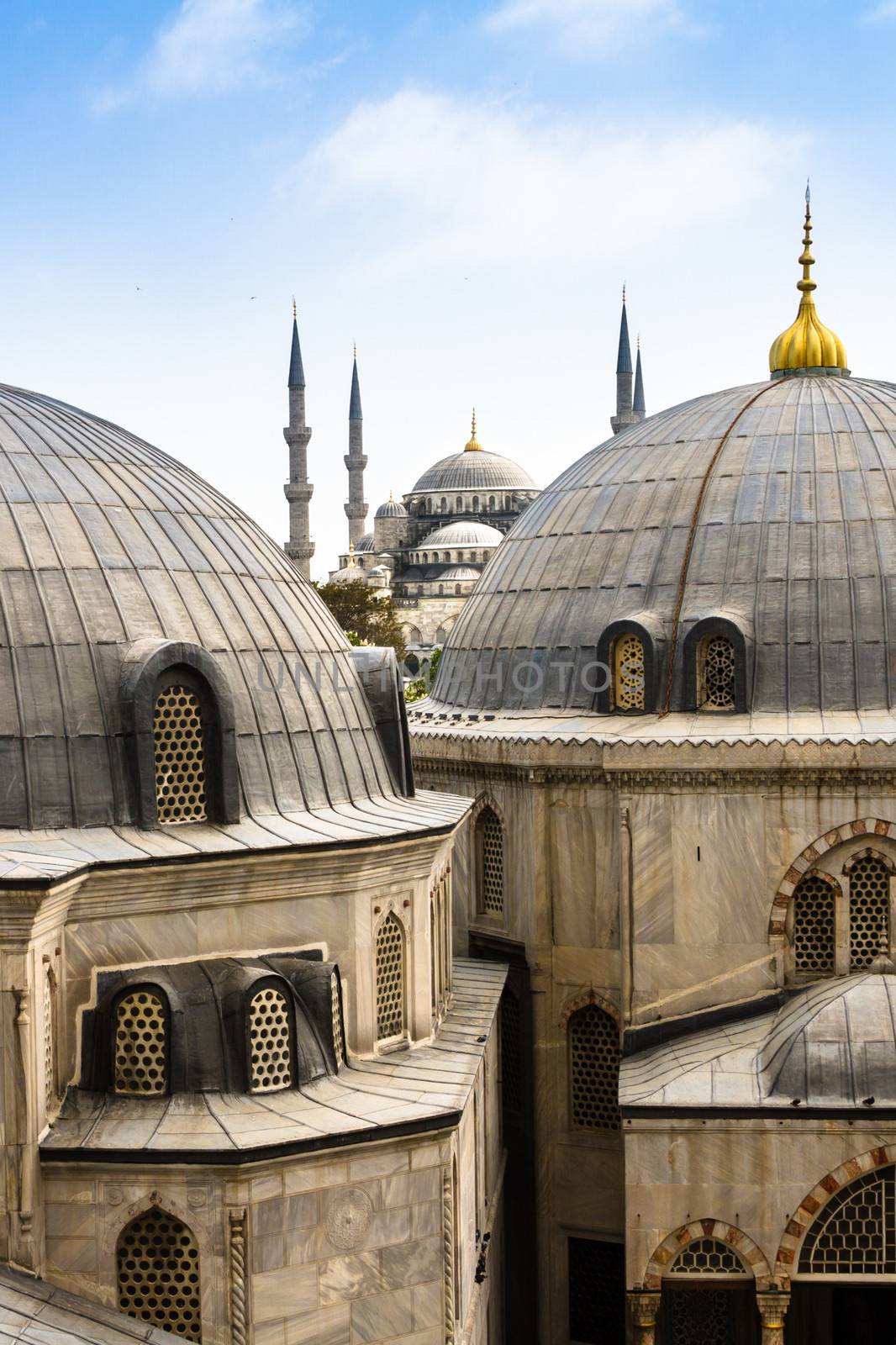 Blue Mosque or Sultan Ahmed Mosque viewed trough the window of Hagia Sophia, former Orthodox patriarchal basilica (church), later a mosque, and now a museum in Istanbul, Turkey.