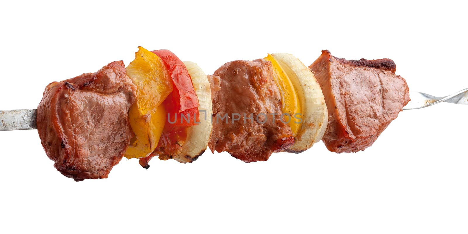 Hot roasted meat with onion, tomato and pepper on the metal skewer