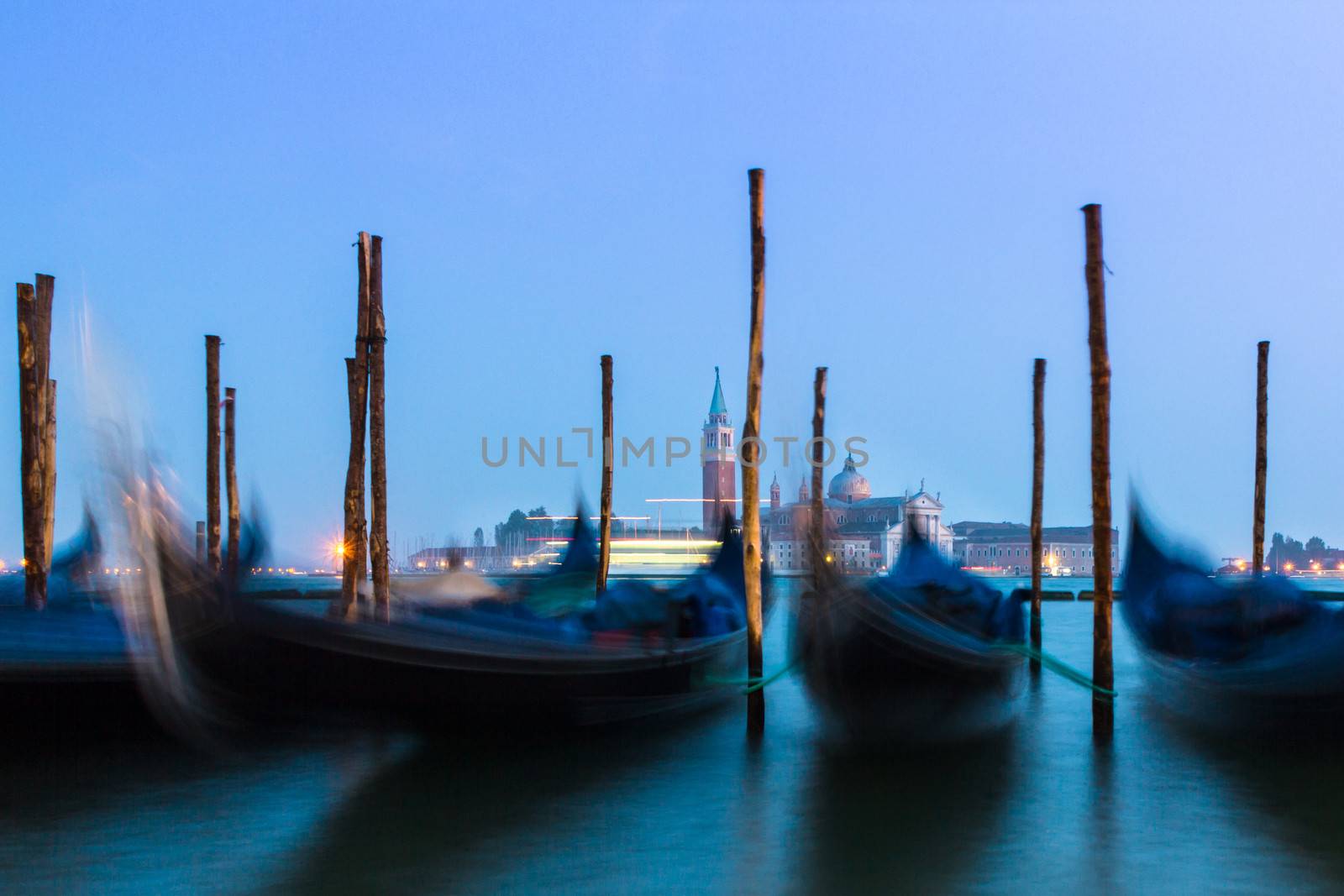 Venice in the evening light with gondolas on Grand Canal against San Giorgio Maggiore church. Italy, Europe. World heritage site.