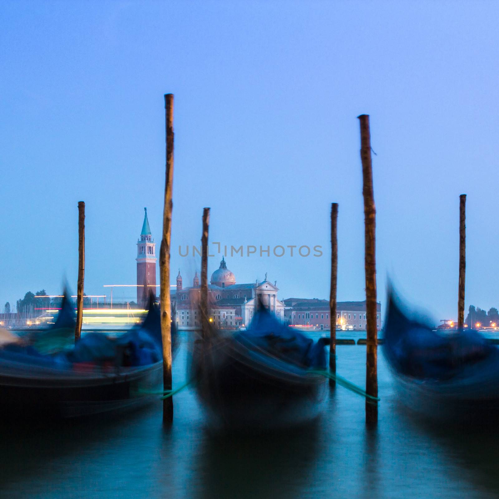 Venice in the evening light with gondolas on Grand Canal against San Giorgio Maggiore church. Italy, Europe. World heritage site.