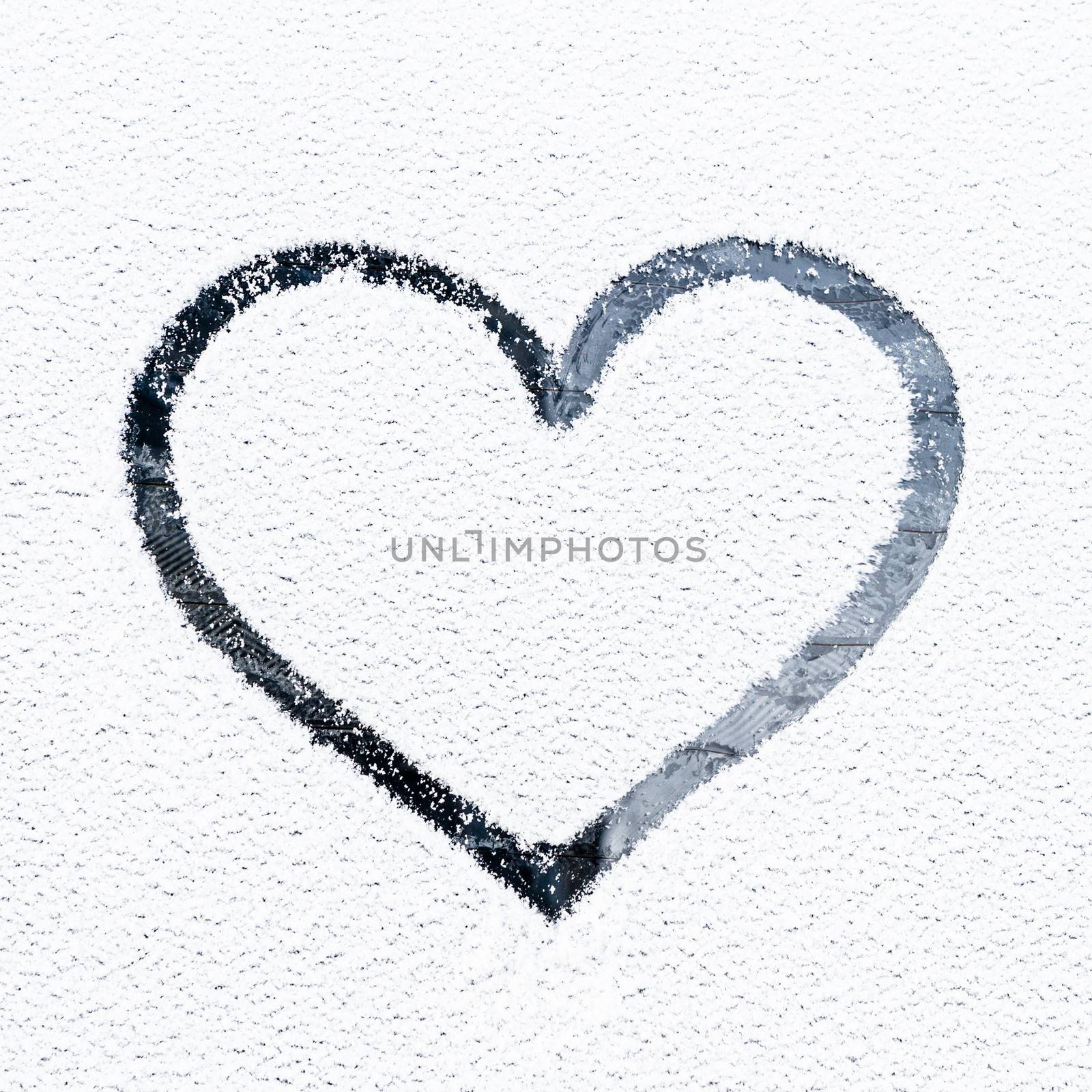 Heart drawn on frosty window. by kasto