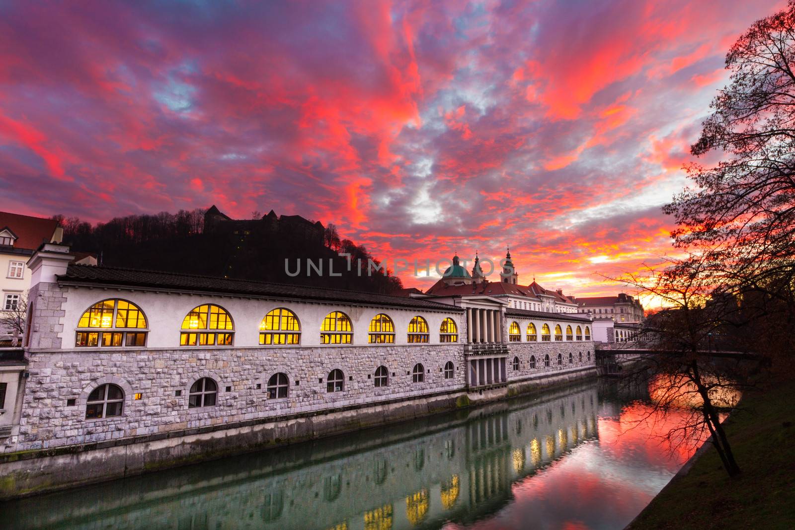 Ljubljana, Slovenia, Europe - Ljubljanica River and Central Market in sunset.  Ljubljana open market buildings was designed by famous architect Jo��e Plecnik.