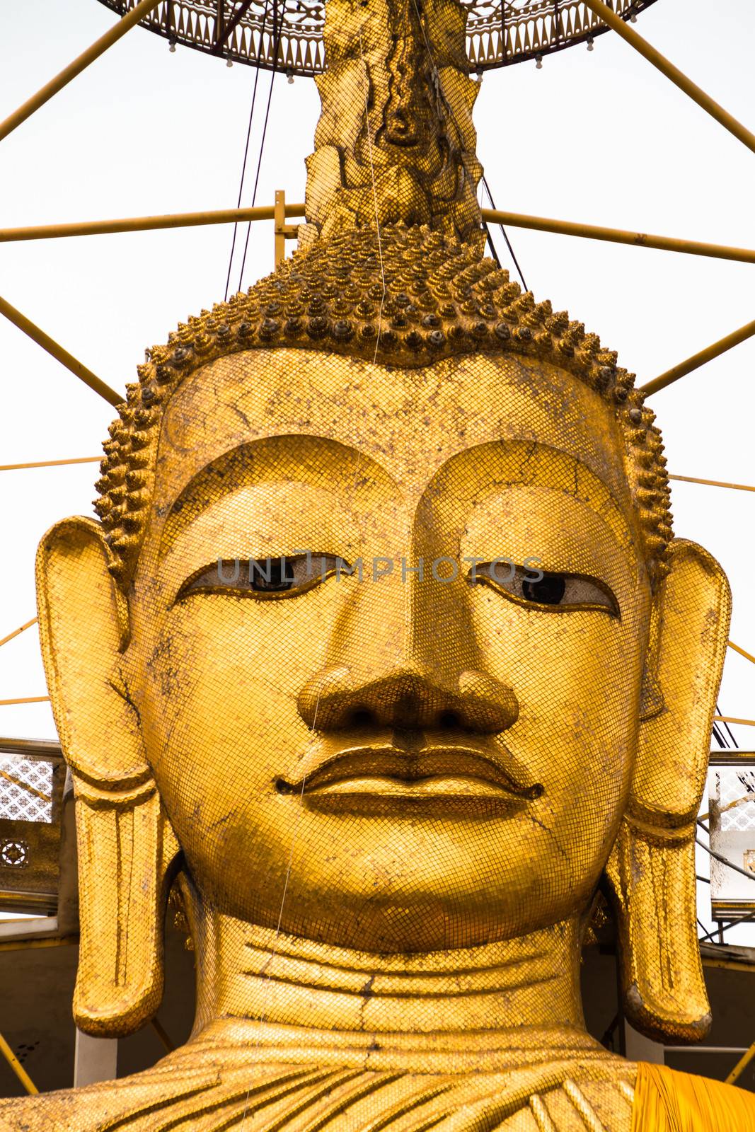 Golden Buddha statue at buddhist temple in Bangkok.