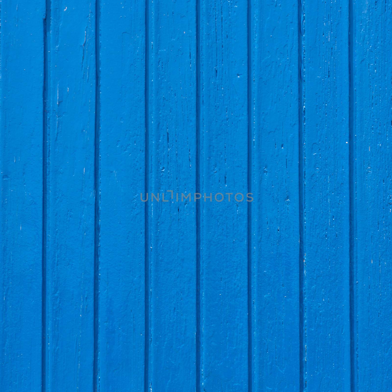 Aged grunge weathered blue wooden window shutter. Can be used as a Mediterranean background.