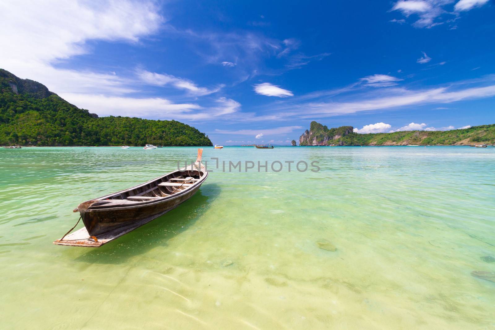Wooden boat on a tropical beach. by kasto