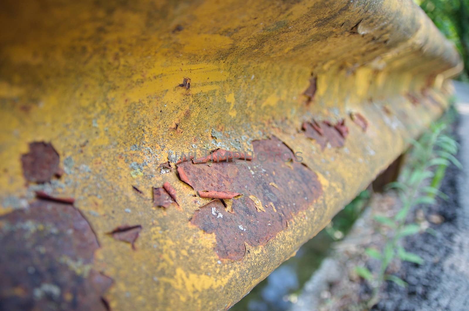 Yellow railings next to a road