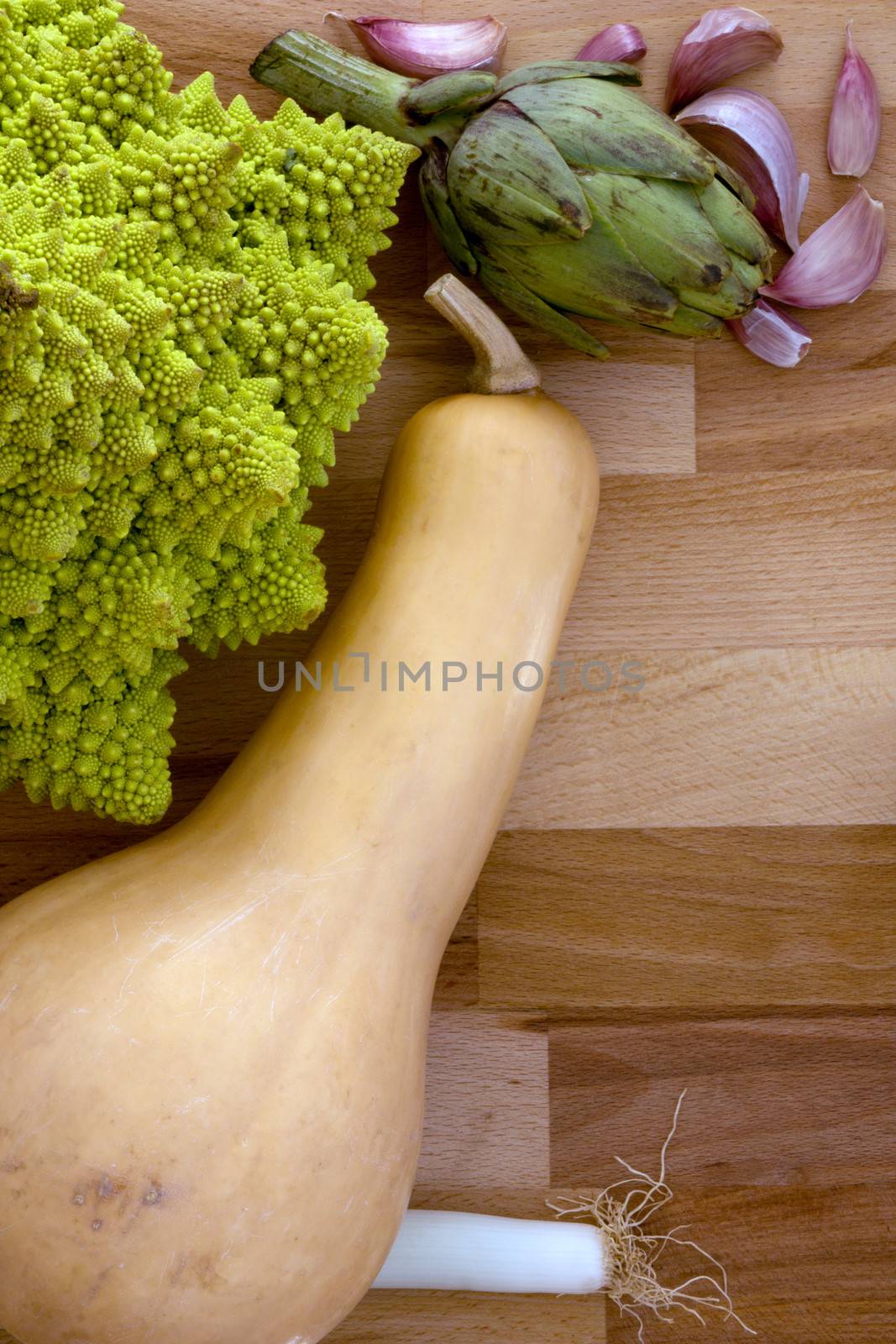 Vegetables on a wooden background with space for text.
