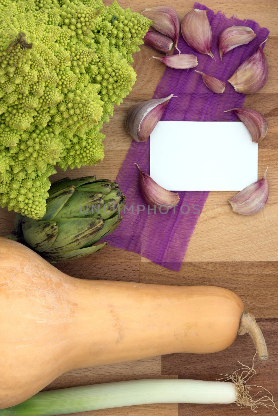 Vegetables on chooping board with white card for text