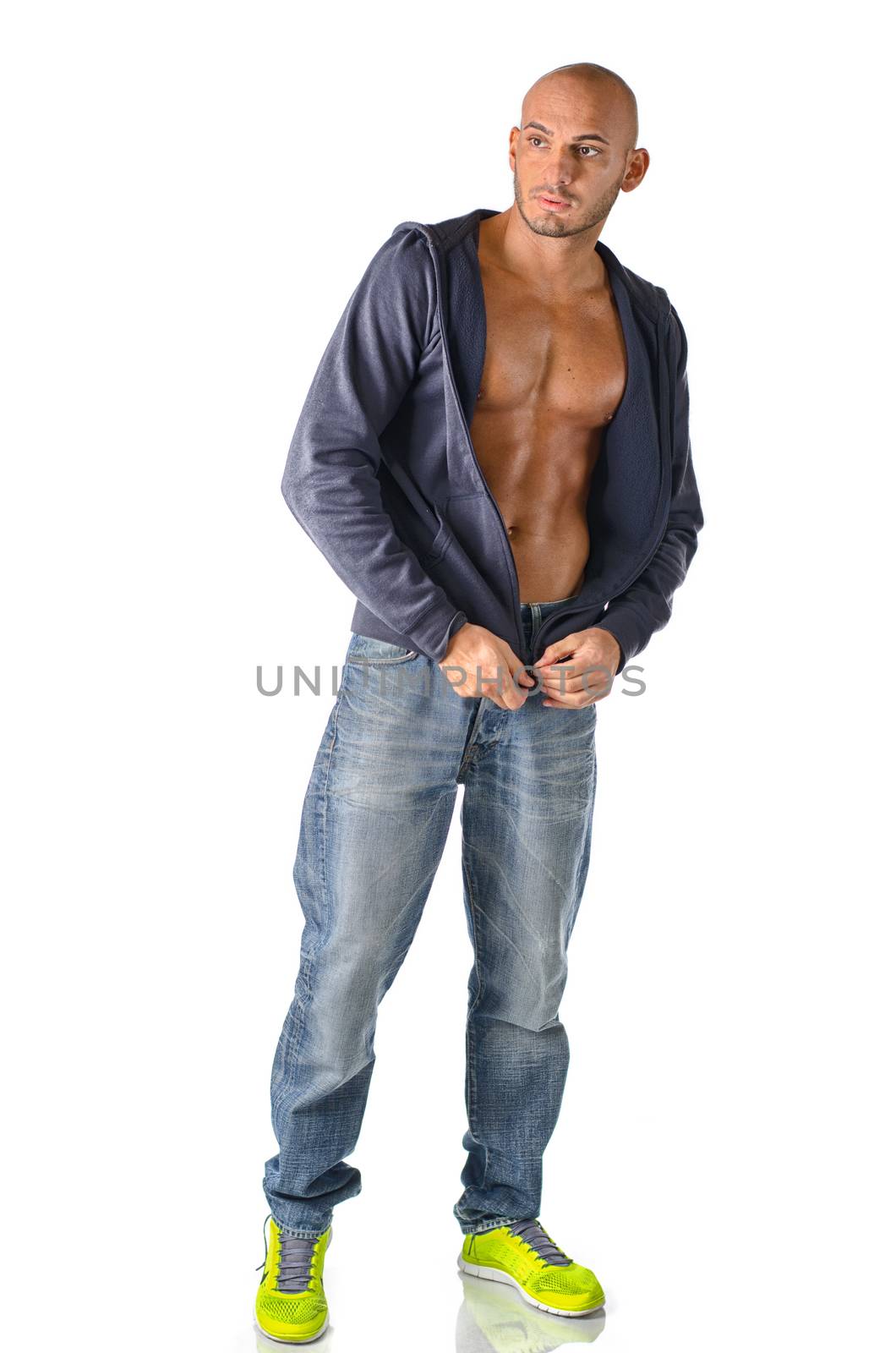 Hip, trendy young man in jeans and open sweater, isolated on white background