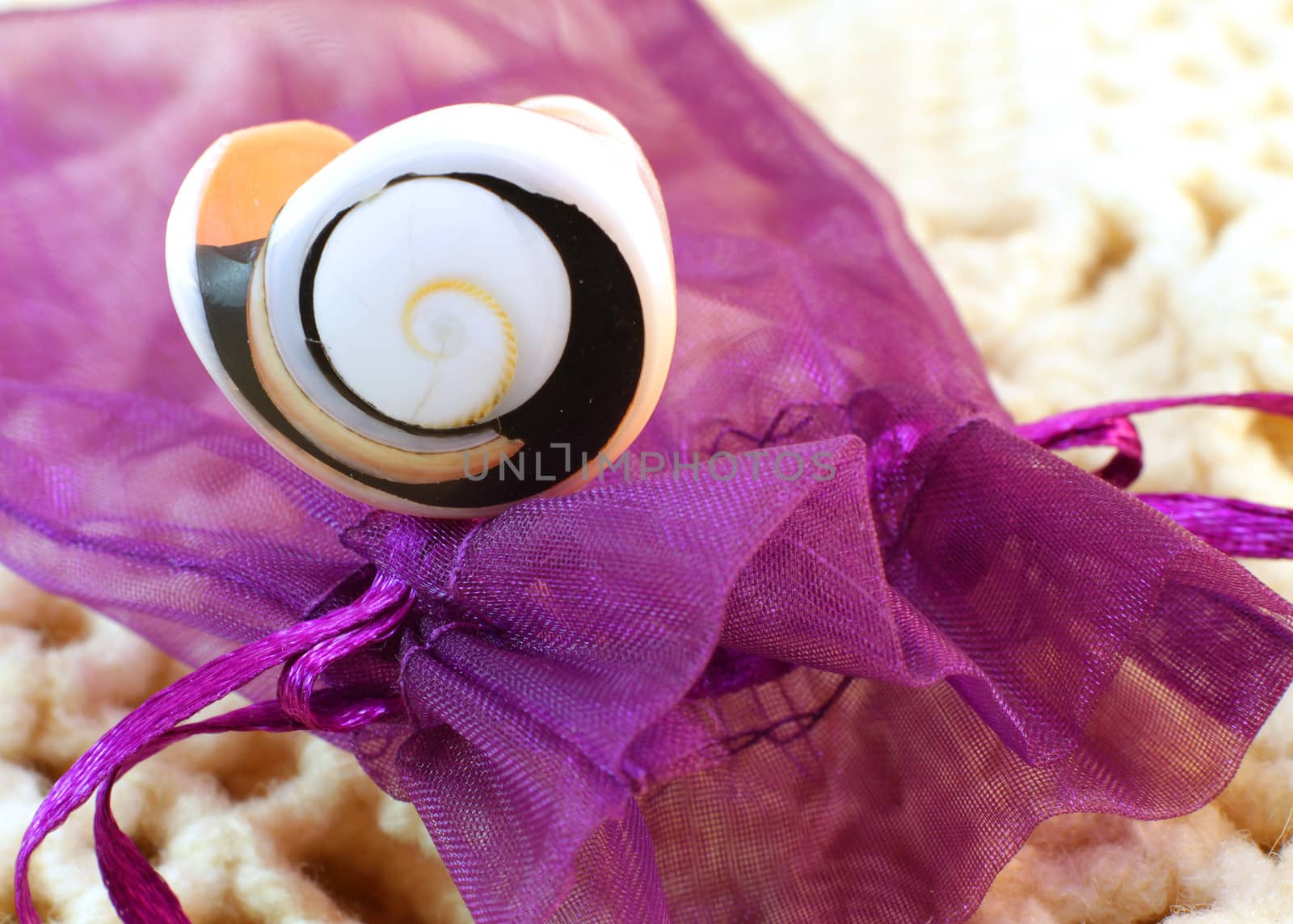 Original handmade ring of sea shell on the knitted background