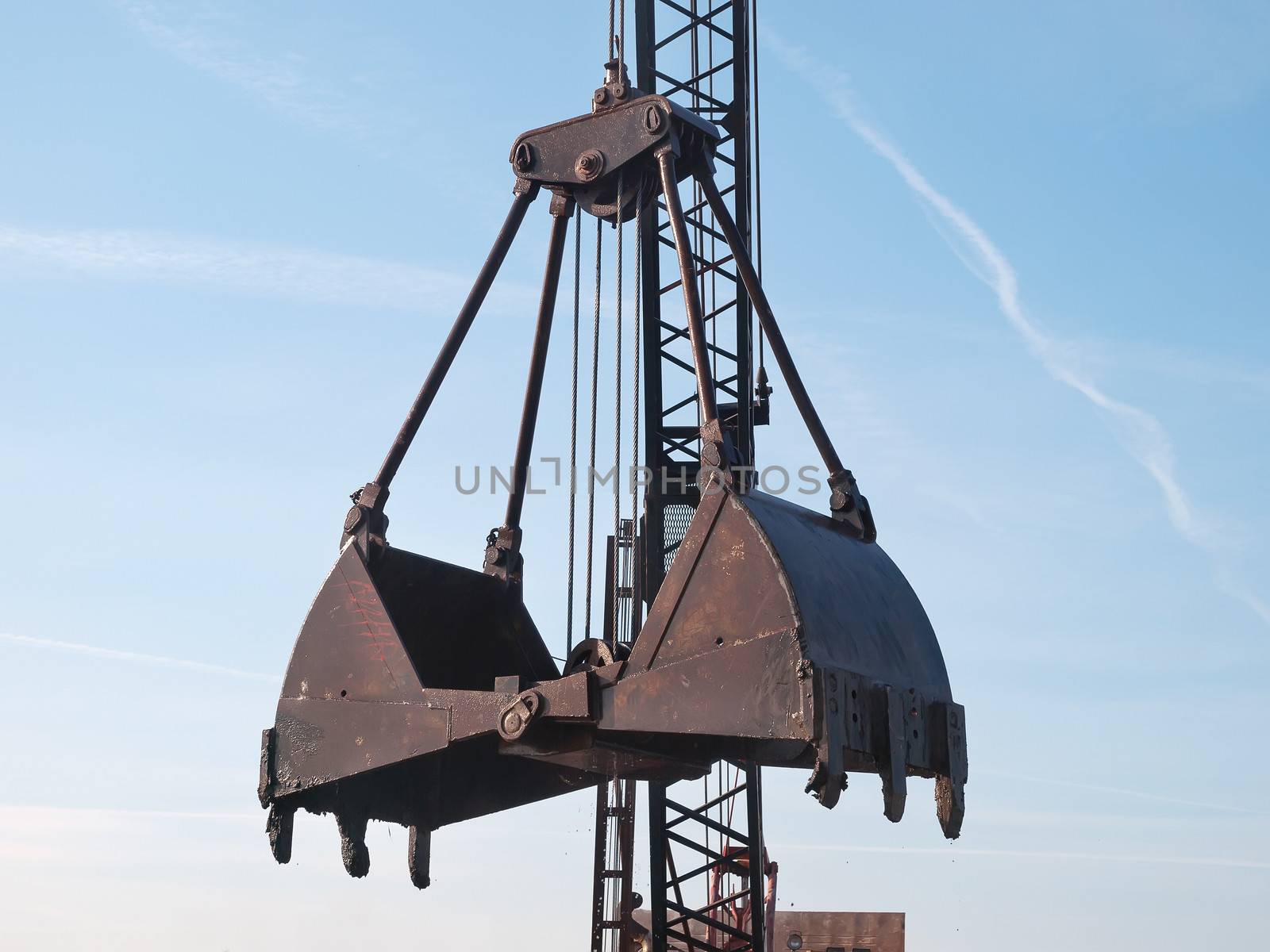 open grab bucket and crane on working site