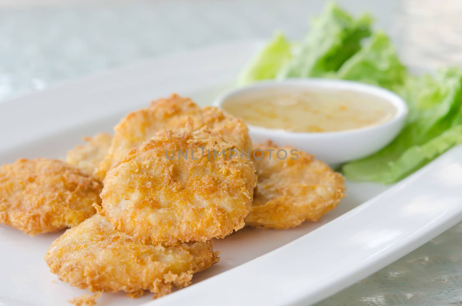 Thai Food Fried Fish Cake (Tod Mun Pla) served with sweet sauce and fresh lettuce