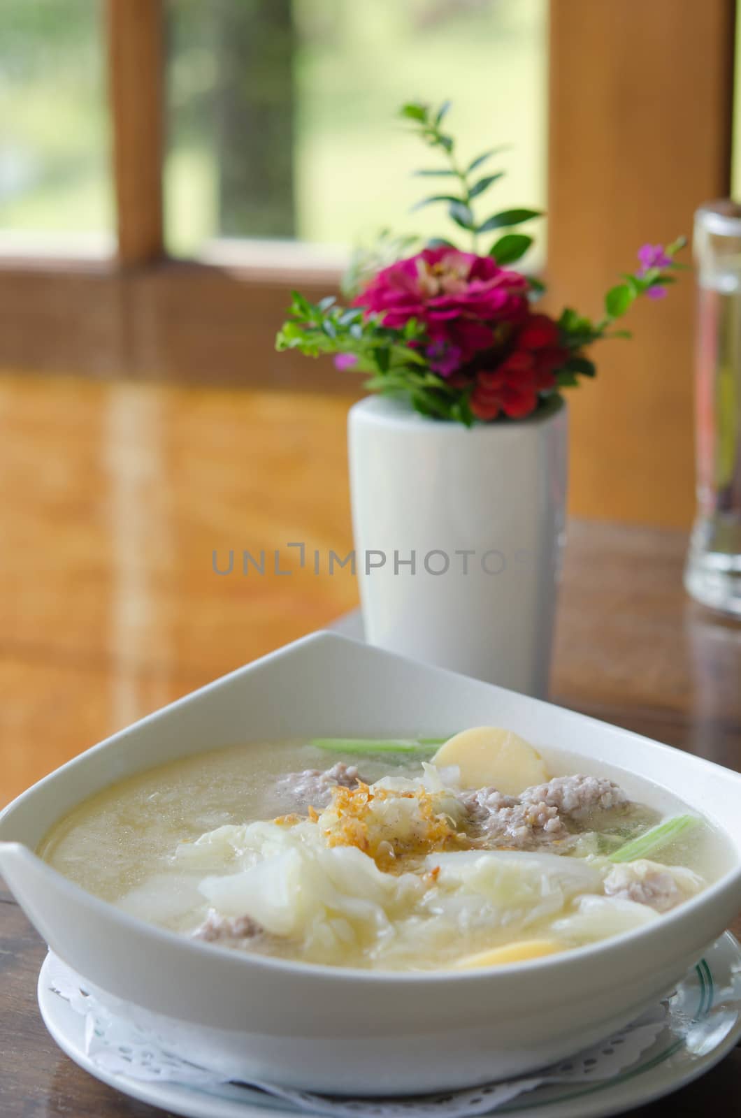 Homemade soup with , pork , meatballs ,   tofu and vegetable in white bowl