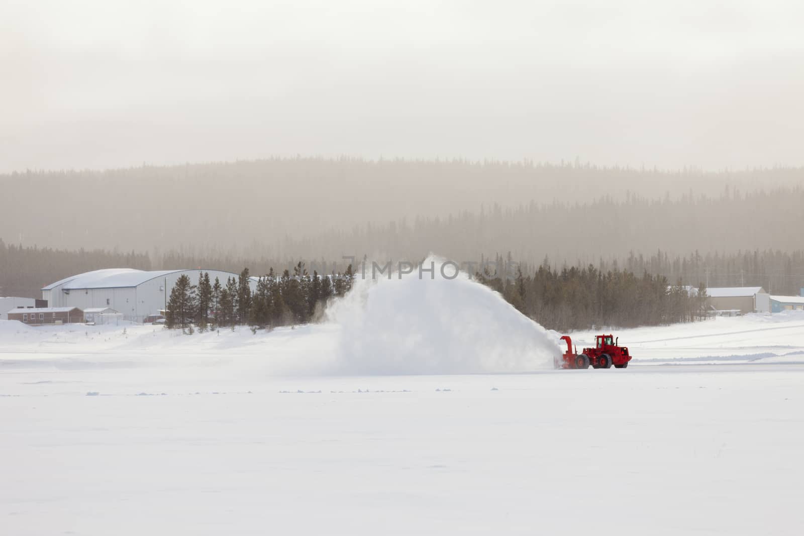 Snow blower clearing road in winter storm blizzard by PiLens