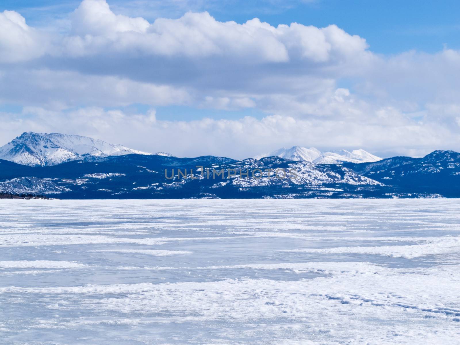 Cold icy winter landscape of frozen Lake Laberge, Yukon Territory, Canada