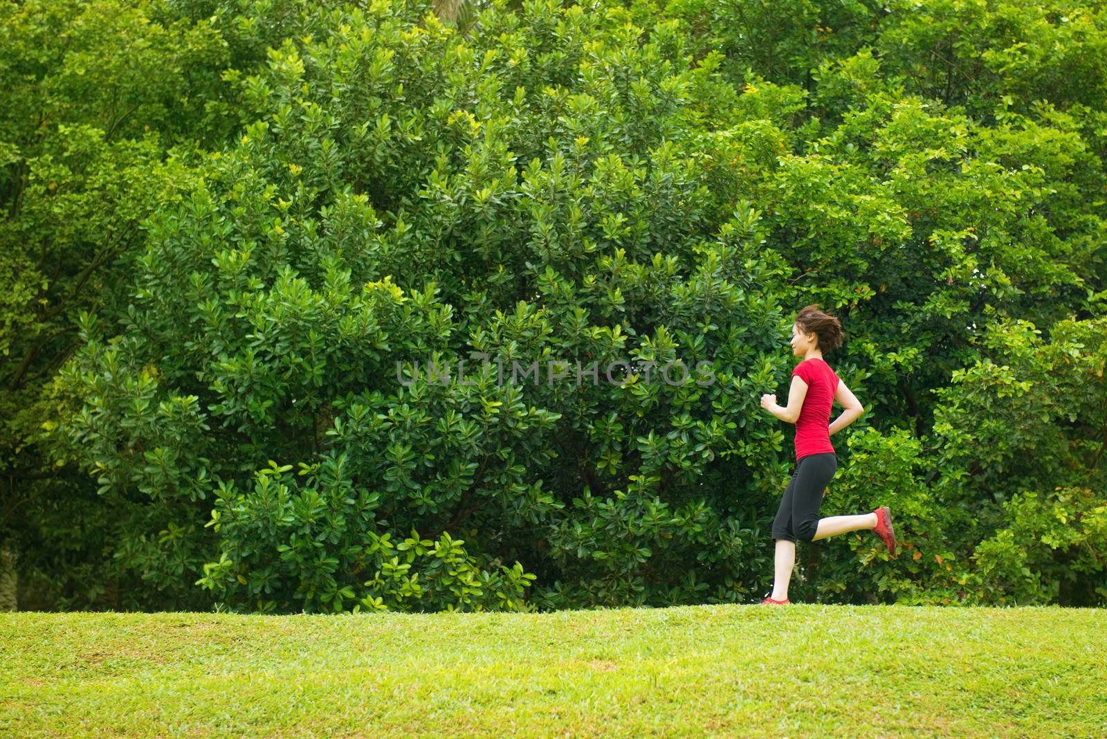 Asian girl jogging at outdoor park