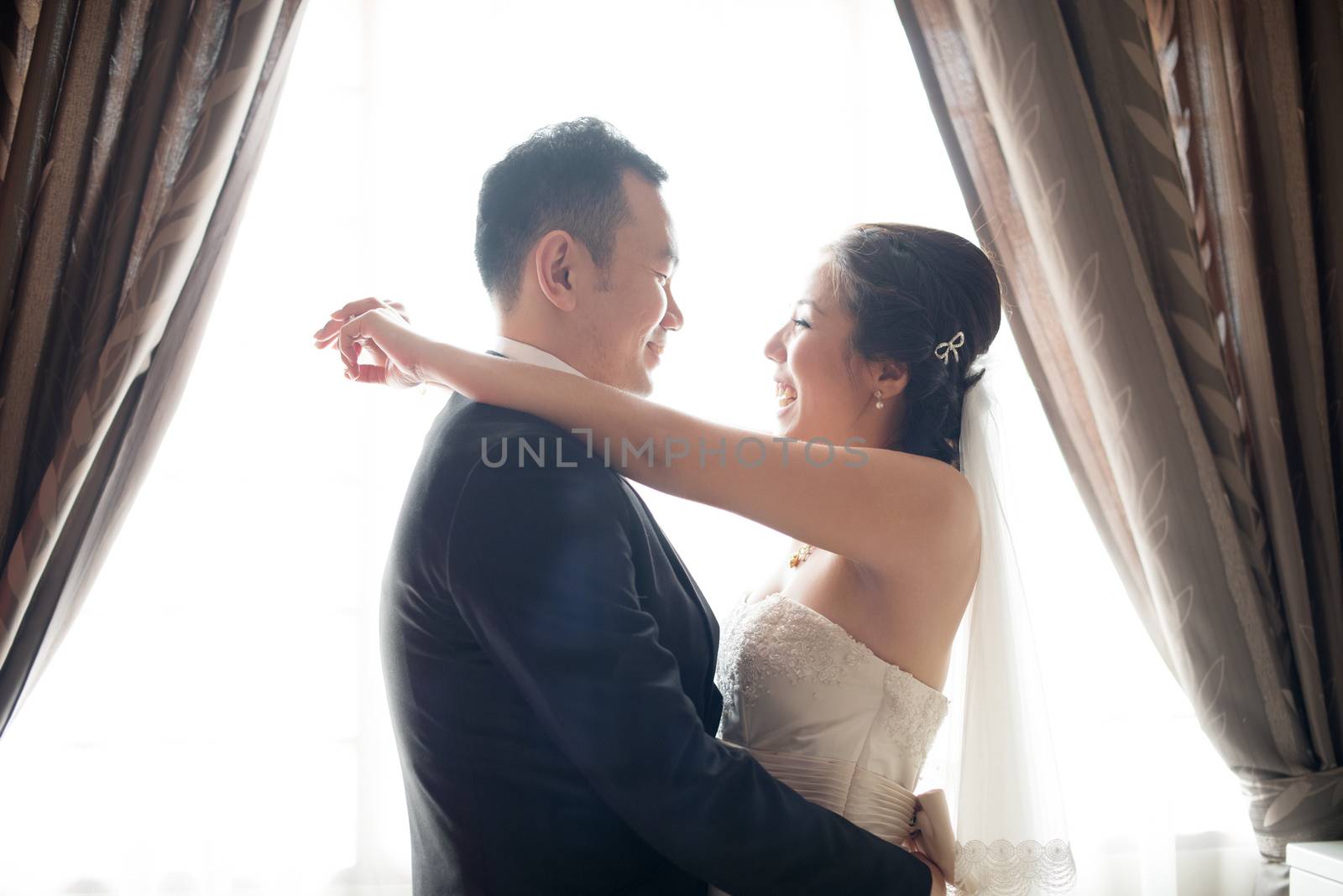 Romantic Asian Chinese wedding couple. Bride and groom dancing on wedding day.