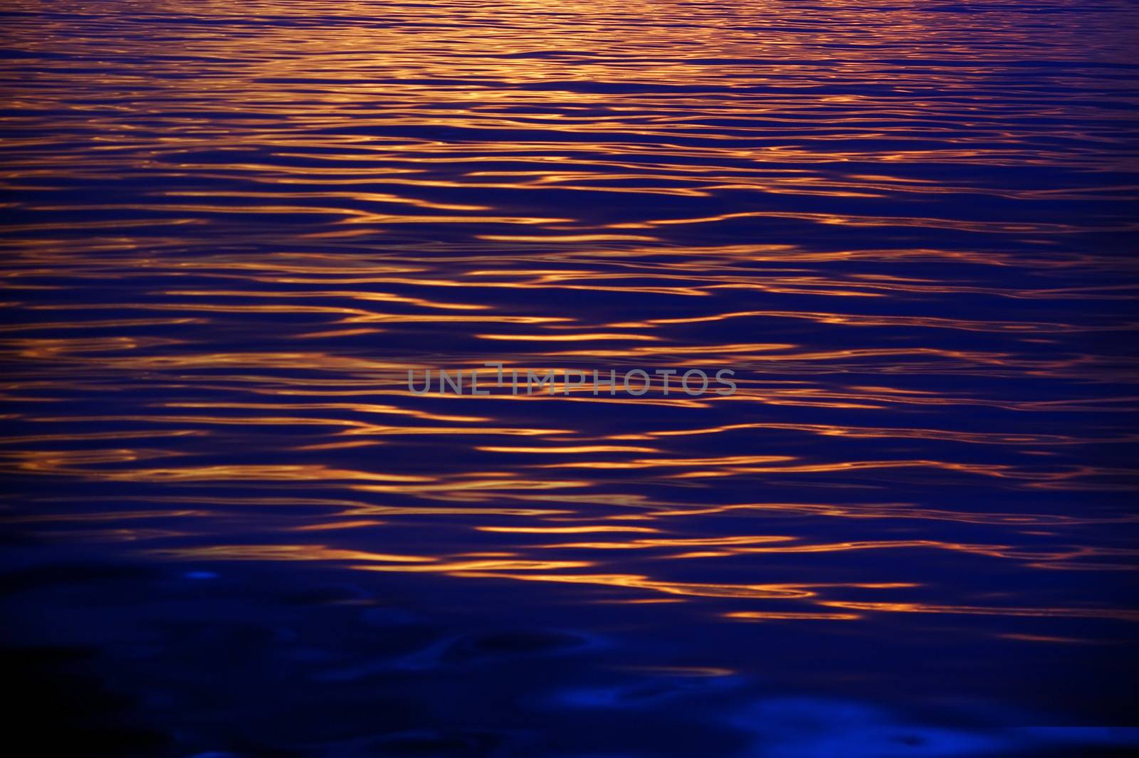 Sunset shining sea, showing beautiful golden and blue ripples