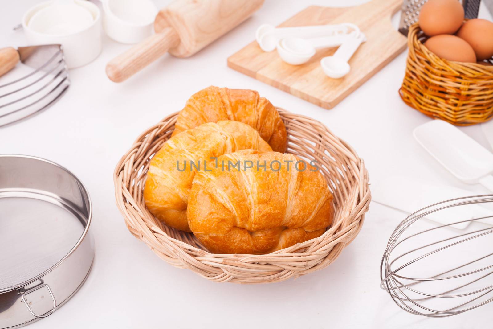 Fresh croissant Placed on the table along with equipment for the bakery.