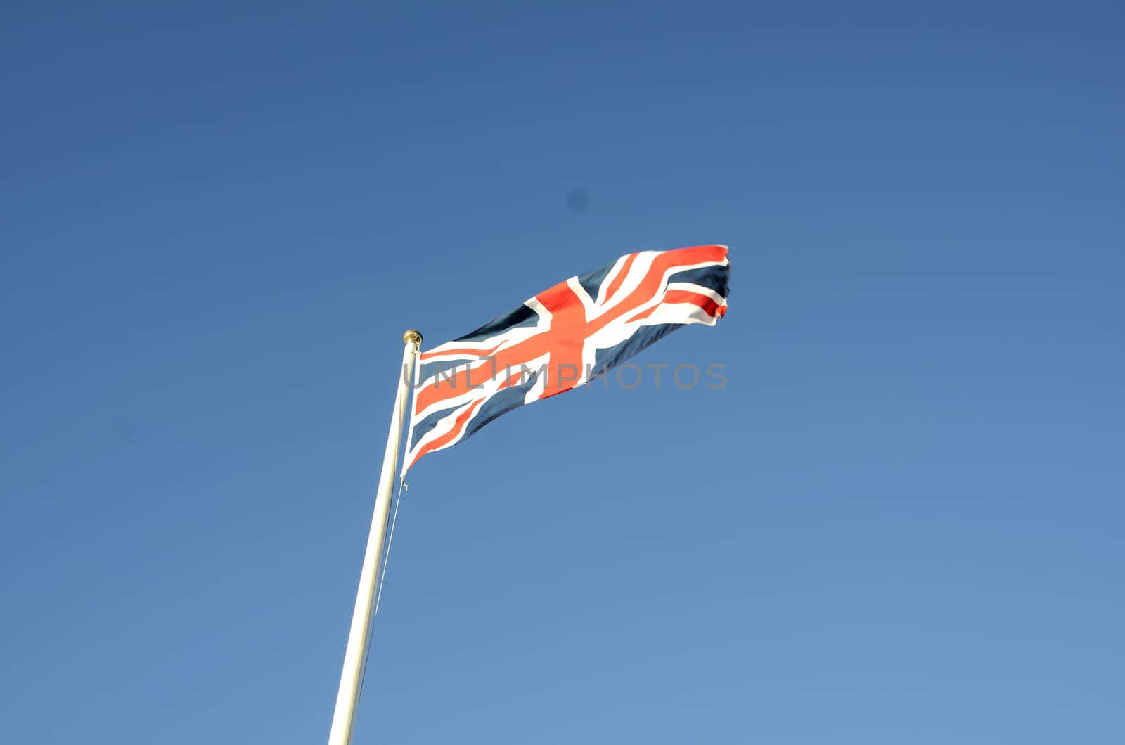 English flag in sunny autumn day against a blue sky