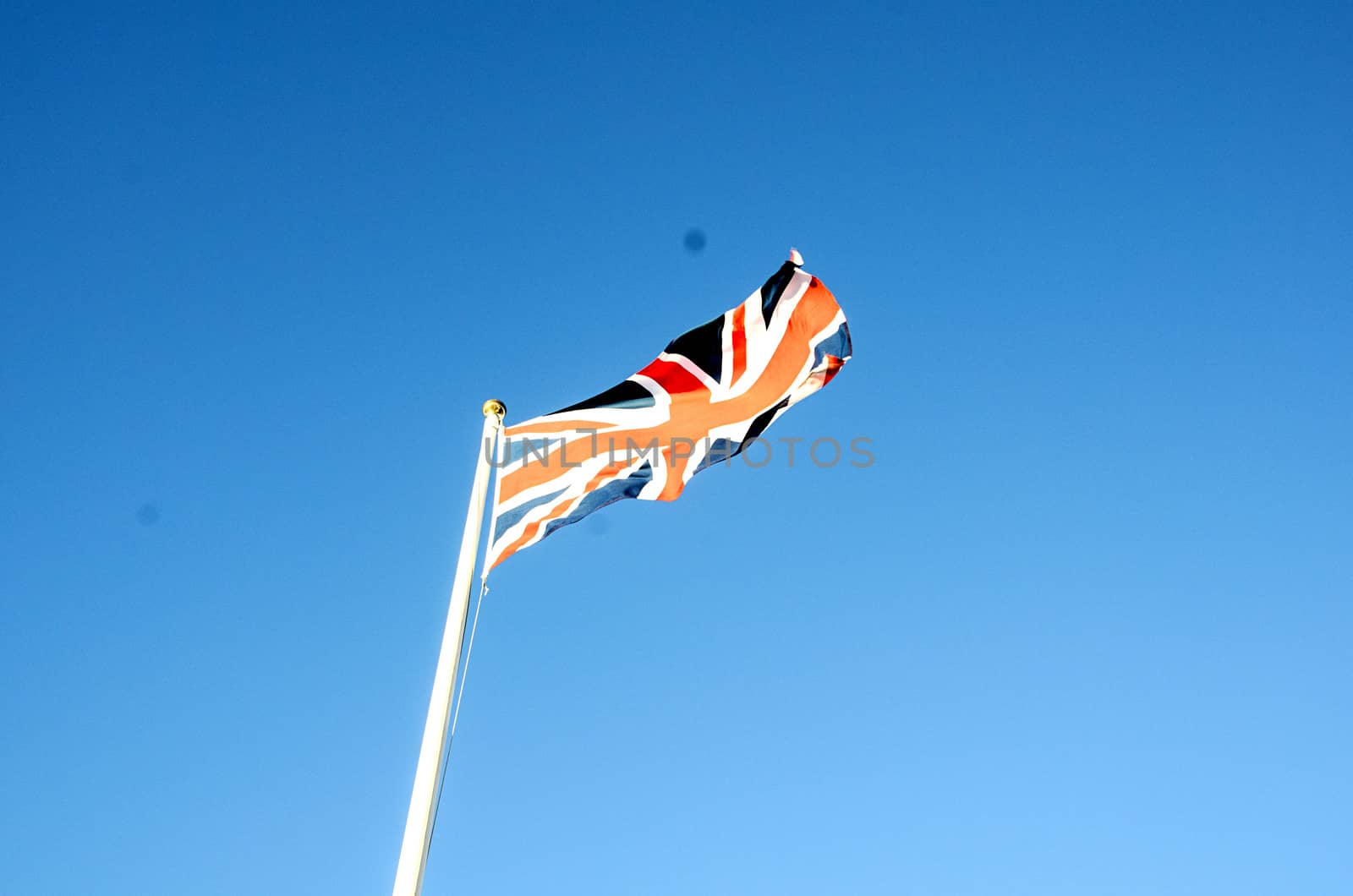English flag in sunny autumn day against a blue sky