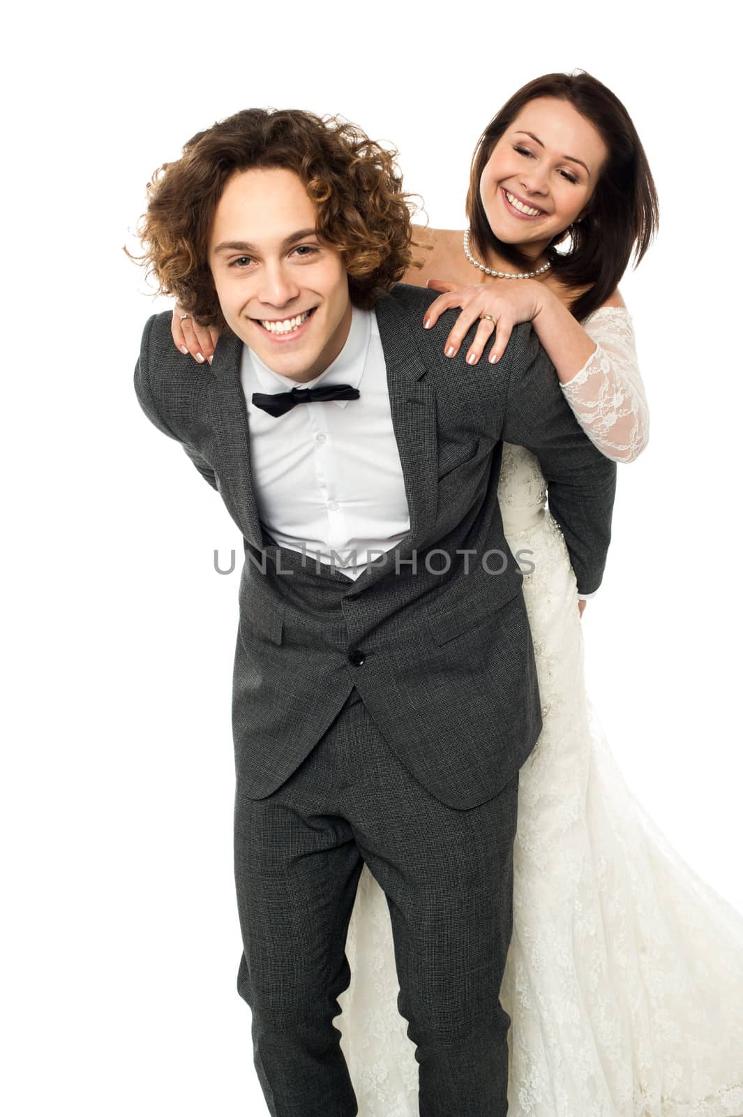 Bridal enjoying piggy ride on her groom's back