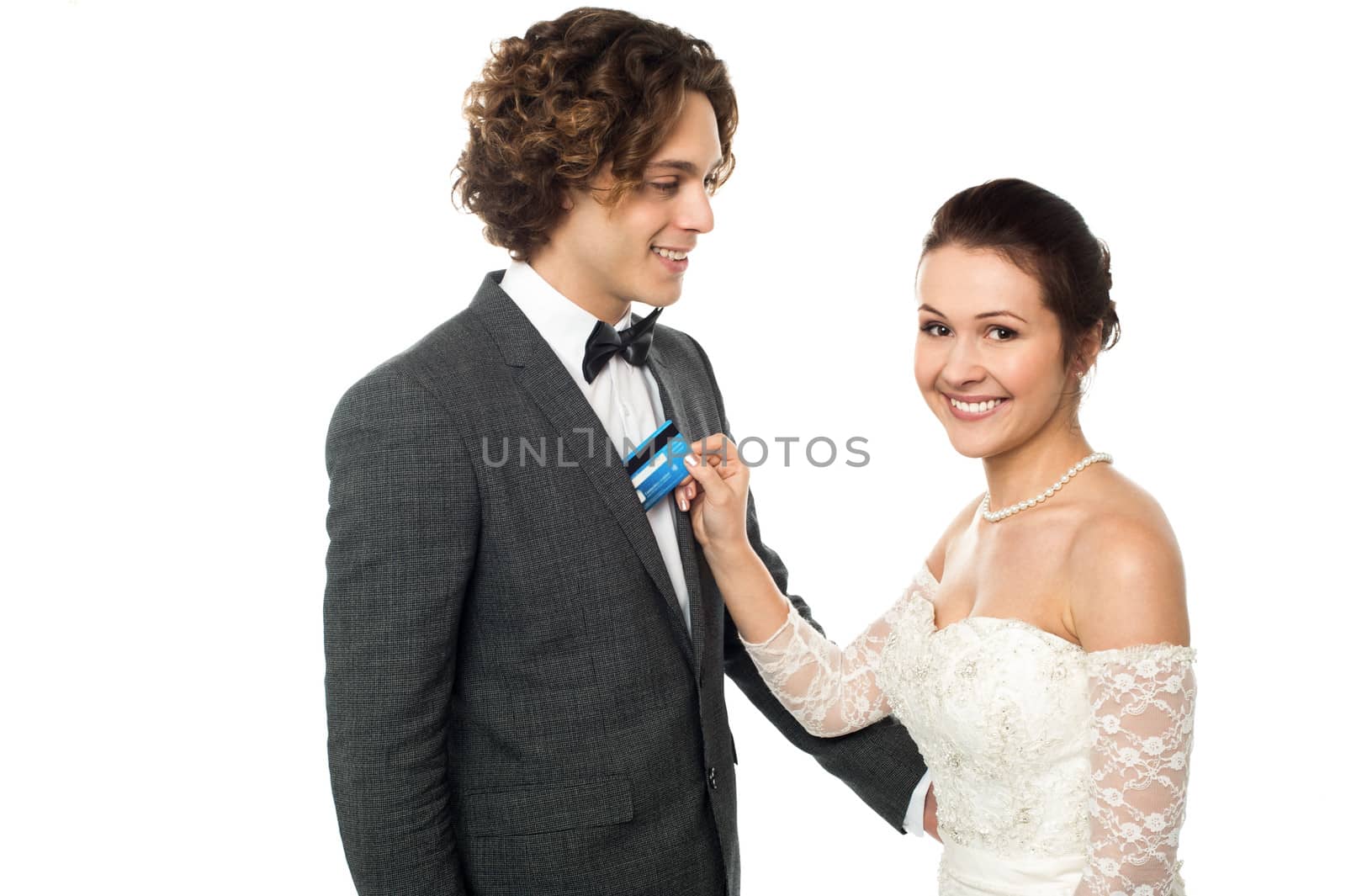 Pretty bride holding debit card by stockyimages