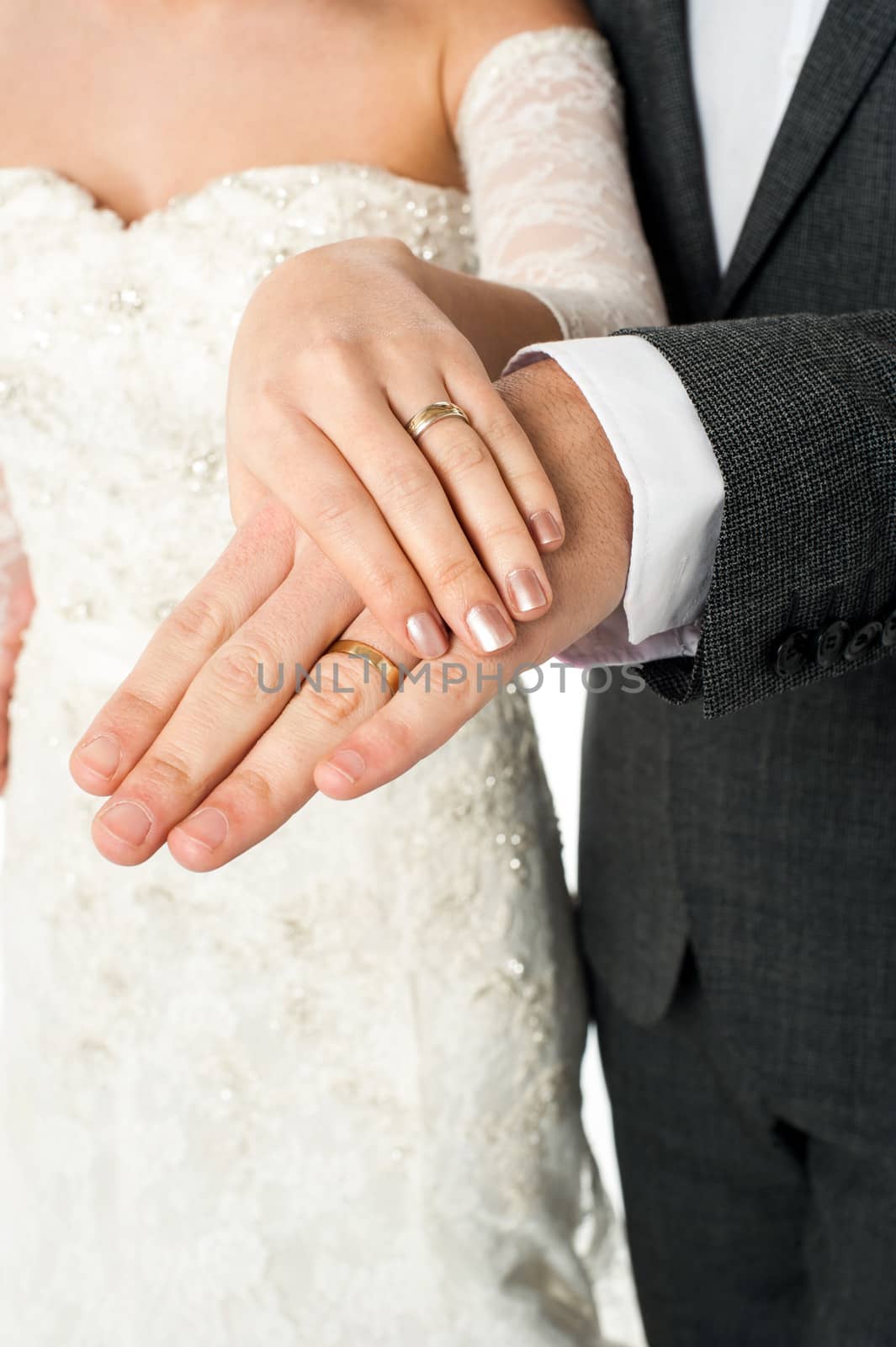 Cropped image of groom displaying their wedding rings